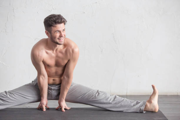 A man doing yoga exercises stock photo