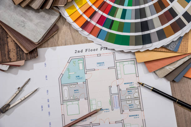 house plan with palette of colors and wooden sampler.