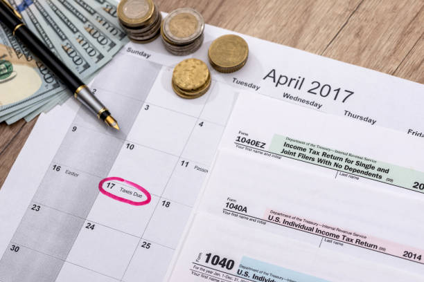 istock calendar, 2017 tax forms with pen and dollars. 647265632
