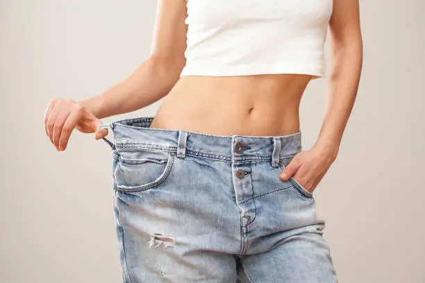 Weight loss woman with bluejeans