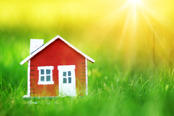 istock red wooden house on the grass 647273652