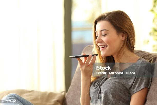 Girl Using A Smart Phone Voice Recognition Stock Photo - Download Image Now - Mobile Phone, Talking, Speech Recognition