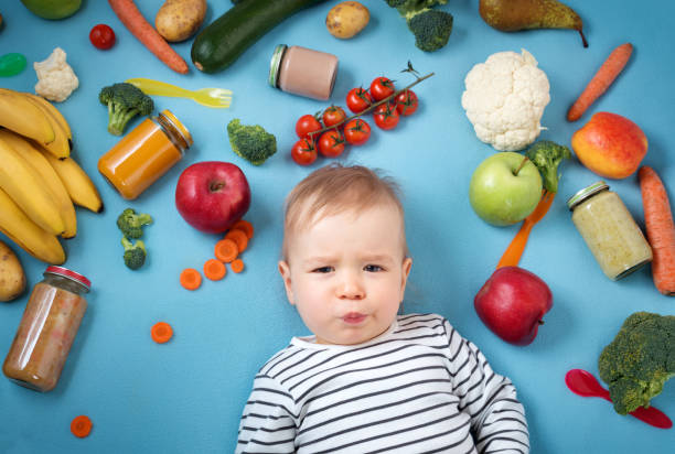 istock Baby surrounded with fruits and vegetables 647284042