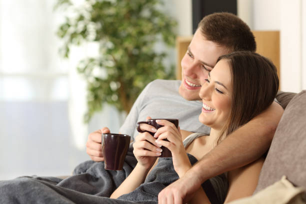 istock Couple relaxing and drinking coffee at home 647288250