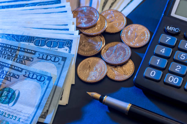 istock US dollars,  coin, calculator and pen. 647289312
