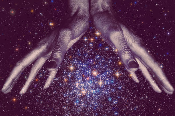 istock God's down hands holding a star galaxy in space 647293332