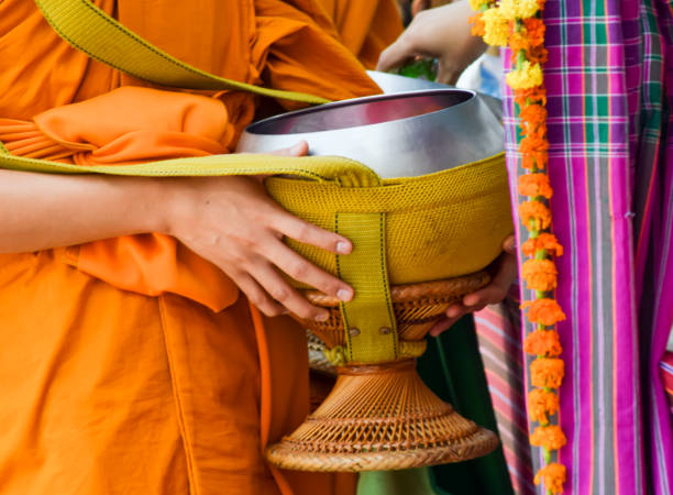 istock give alms to a Buddhist monk on morning 647294126