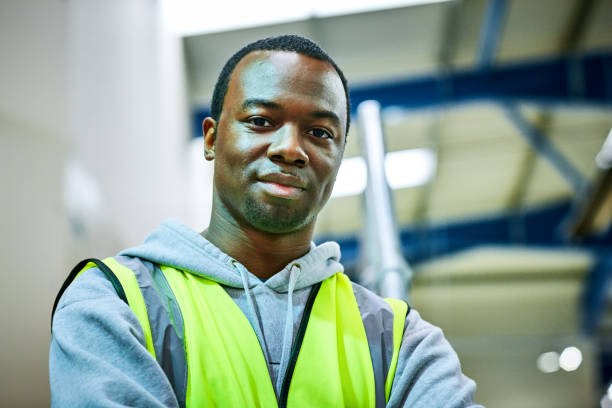 istock Confident african man standing in factory 647297466