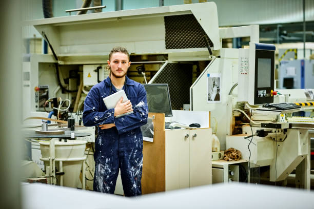istock Young male worker standing in factory 647297554