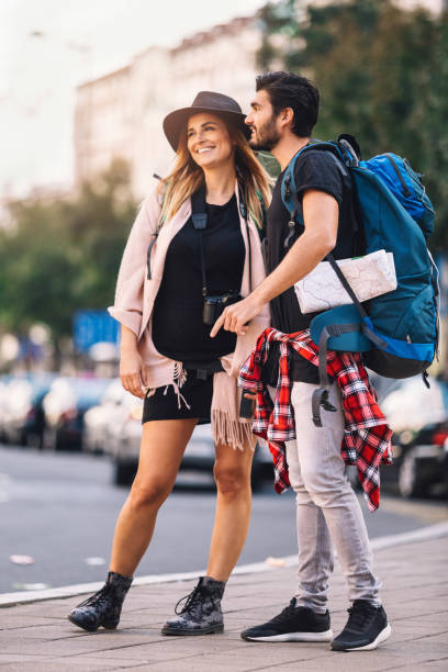 istock Backpackers couple in the city walking 647297564