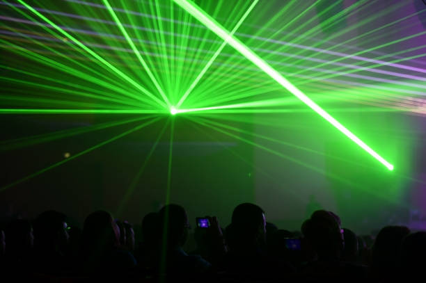 istock People watching a beautiful laser show 647304288