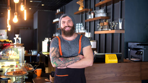 istock Bearded and tattooed hipster coffee shop owner posing 647313206