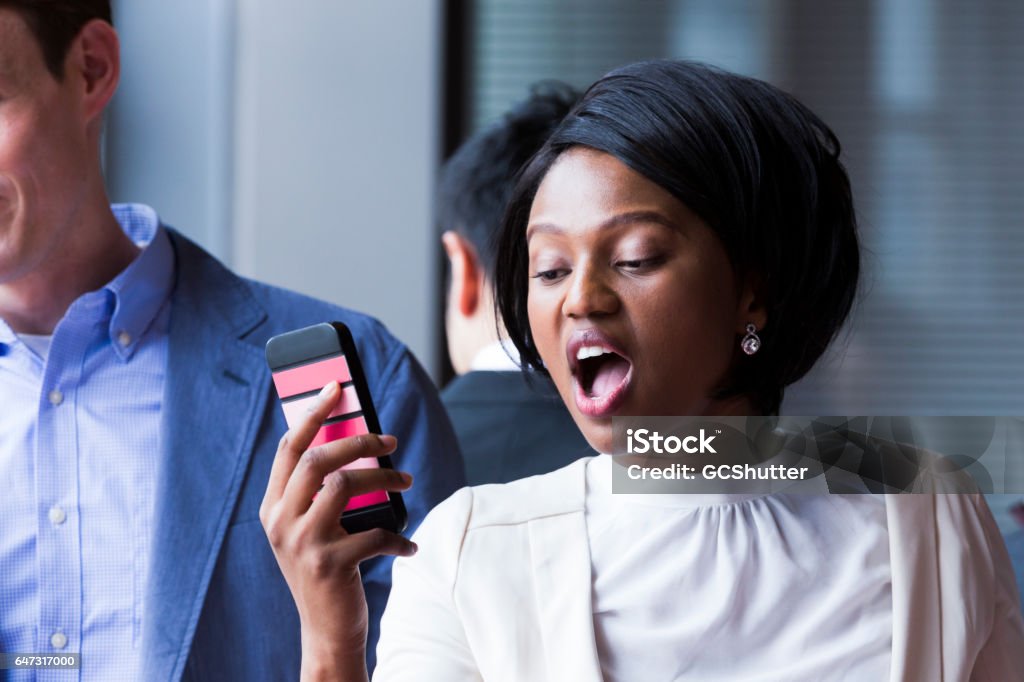 Please stop calling me! I am at a training program. A business woman getting upset with repetitive calls during a training program. Phone Cover Stock Photo