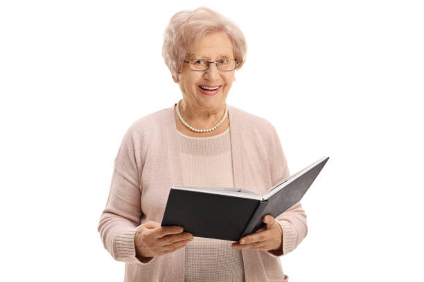 istock Elderly woman with a book smiling 647320422