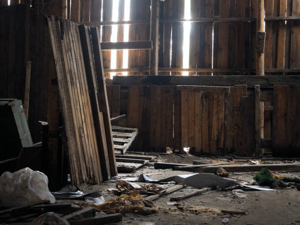 istock Rubbish, garbage in an old wooden barn. Rays of light 647322140