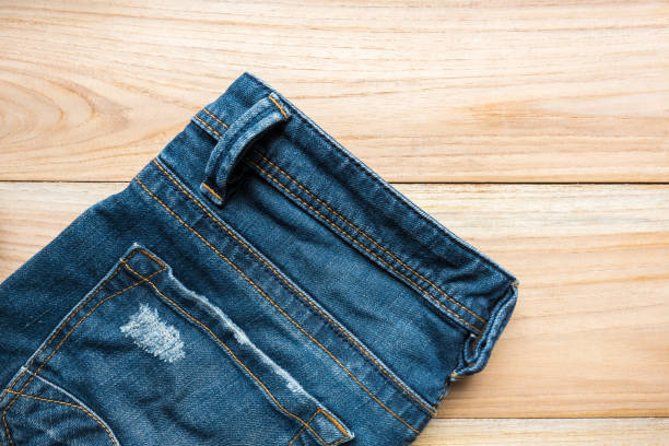 istock jeans on wooden backgrounds 647324408