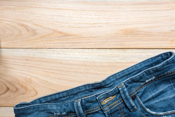 istock jeans on wooden backgrounds 647324416