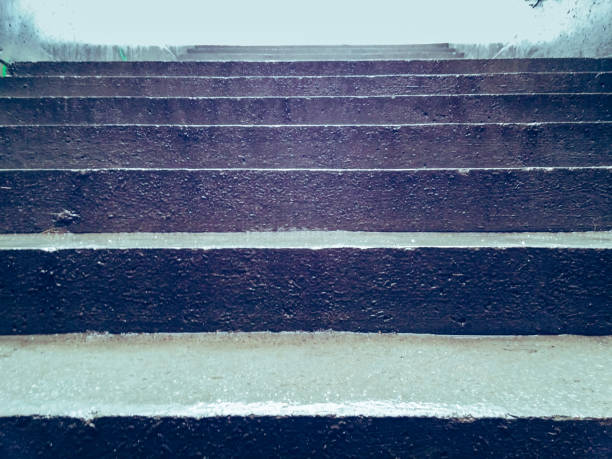 istock Low angle view of modern wet concrete stairs. 647327942