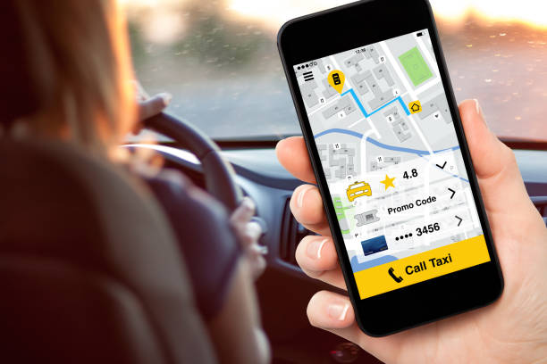 istock hand holding phone with application call taxi on screen 647343036