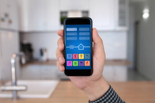 istock male hand holding phone with app smart home kitchen house 647343236