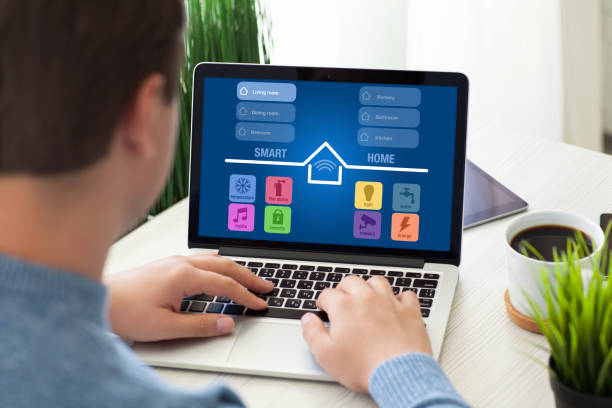 istock man sitting in room with notebook app smart home screen 647344340