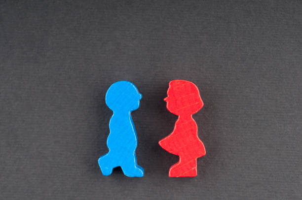 istock Two wooden dolls on a black background 647344588