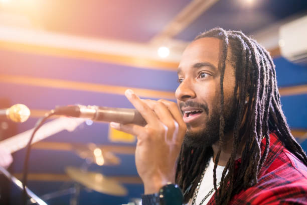 istock Music band singer singing a song in studio 647344590