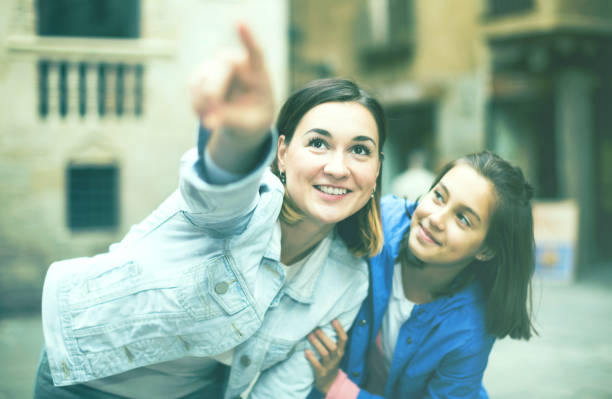 istock Mother and daughter pointing at sight during 647345132