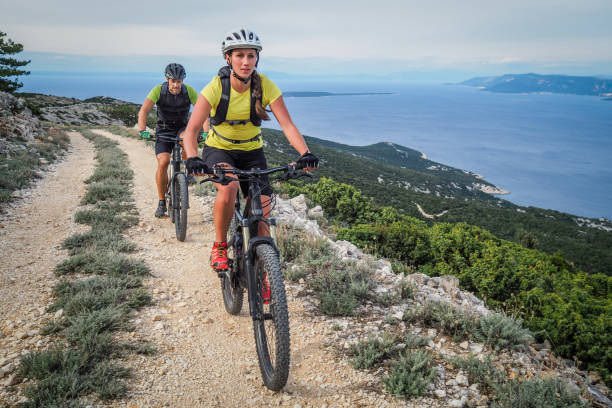 istock Couple cycling at coastline 647345258