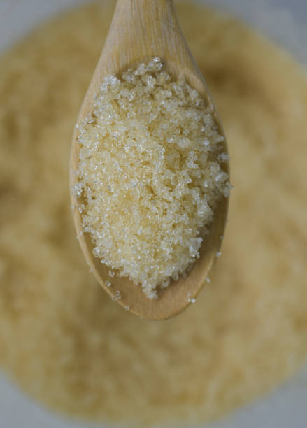 istock closeup sugar on wooden spoon 647347898
