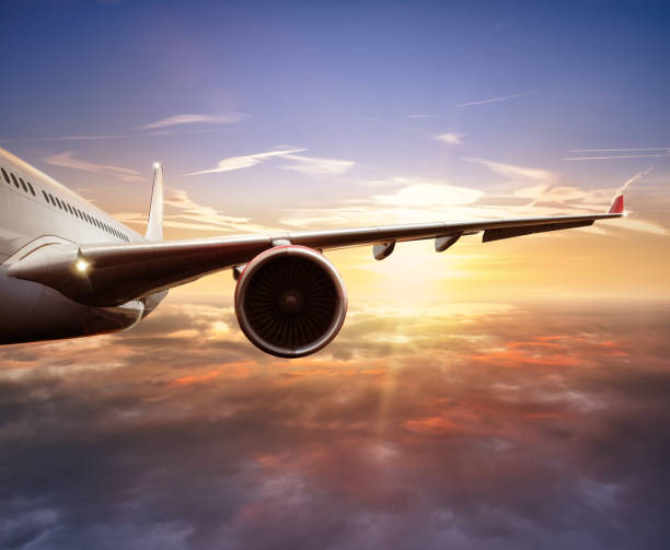 istock Close-up of passenger airplane flying above clouds 647348806