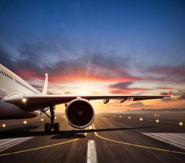 istock Close-up of airplane on runway in sunset light 647348864