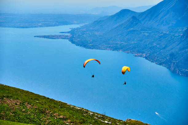 MONTE BALDO, ITALY, August 17 2014: Paragliding is a popular activity on Lake Garda. Taking off from Monte Baldo. Tandem paragliding on Garda Lake and Monte baldo