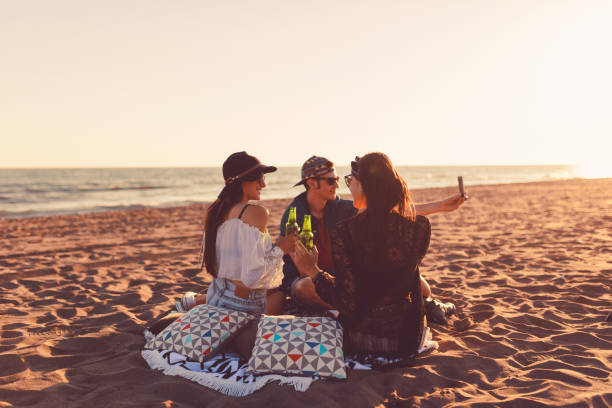 istock Friends taking a selfie on the beach bohemian style 647352222