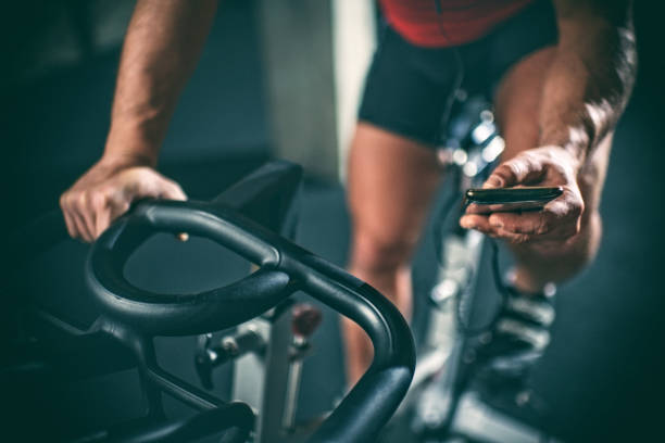 uomo sulla cyclette - spinning instructor exercising gym foto e immagini stock