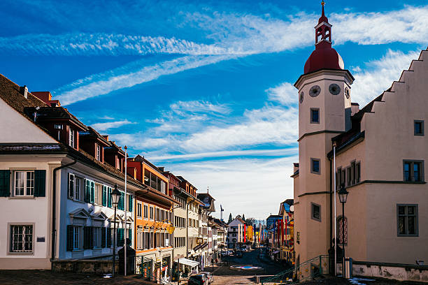 istock Low Angle View Of Clock Tower Building By Road Against Sky On Sunny Day 647367769