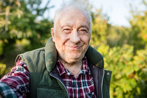 Senior man, making selfie in his vineyard.