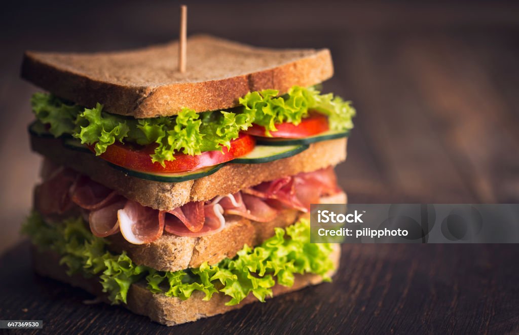 Delicious sandwich with ham, cheese, bacon and lettuce Delicatessen Stock Photo
