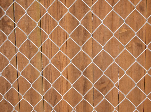Metal and wood fence Horizontal photo of galvanize metal and wood fence wood and wire fence designs pictures stock pictures, royalty-free photos & images