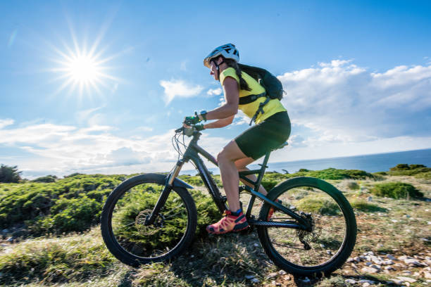 istock Woman mountain biking 647385138