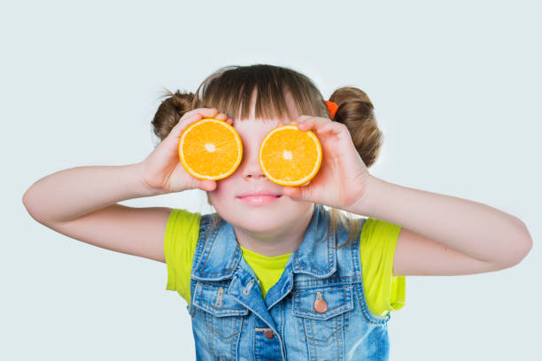 istock Baby a smile and orange on white background 647388080