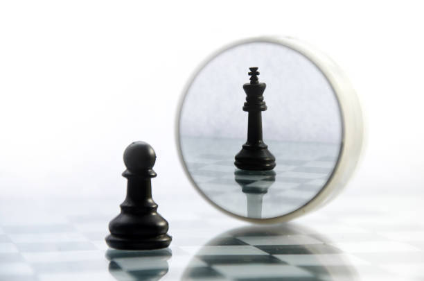 pawn pieces on the chessboard, the reflection in the mirror king pawn pieces on the chessboard, the reflection in the mirror king, often in life things and people are not what they seem pawn chess piece photos stock pictures, royalty-free photos & images