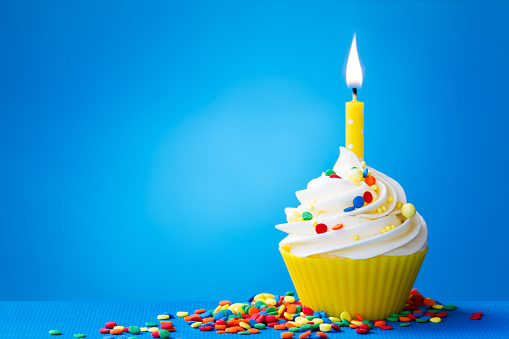 Birthday cupcake with a single yellow candle