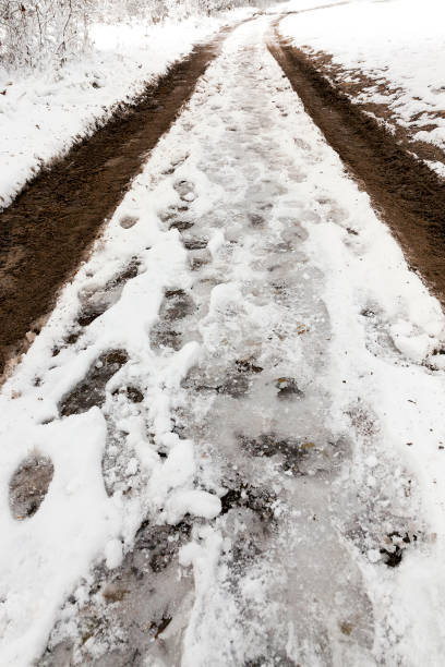 istock traces of the car on snow 647403198