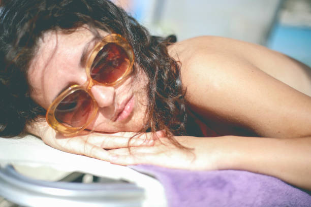 istock Beautiful young women lying on a sunbed 647405842