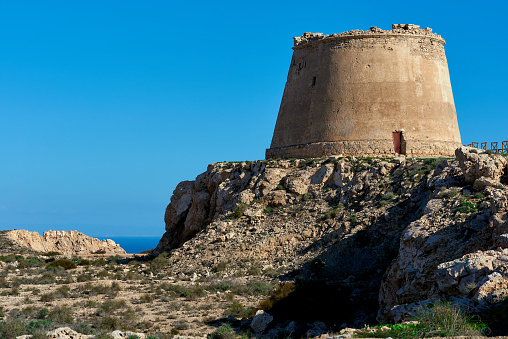 View to the Mesa Roldan. Tower of 18th Century, lies on a mountain, east of the village of Agua Amarga in the province of Almeria. Cabo de Gata-Nijar Natural Park. Spain
