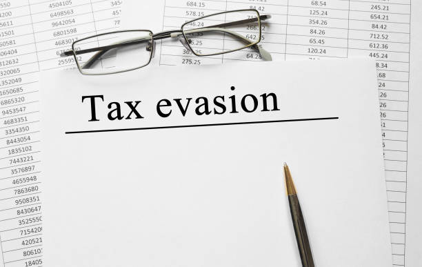istock Paper with Tax evasion on a table 647412690
