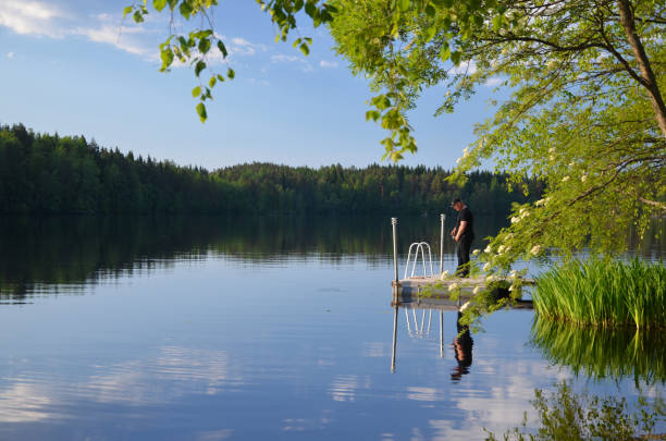 Fisherman in Finland Men fishing in Finland on lake Saimaa lappeenranta stock pictures, royalty-free photos & images