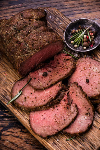 istock Roast beef on cutting board with salt and pepper. Top view. 647419124