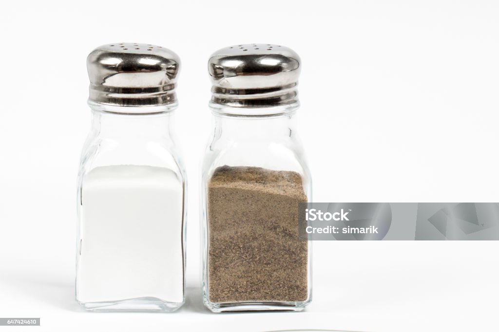 Salt and Pepper Salt and pepper shaker on white background. Pair Stock Photo